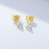 Gold stud earrings with three-prong settings featuring small diamond stones with visible earring backs