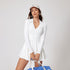 This white long-sleeve tennis dress has a flattering V-neck collar, a fitted waist, and a flared skirt, offering both style and comfort for workouts or casual outings