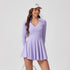 The lavender long-sleeve tennis dress showcases a feminine silhouette with a collared V-neck, a pleated skirt, and a sleek fit, blending elegance with functionality