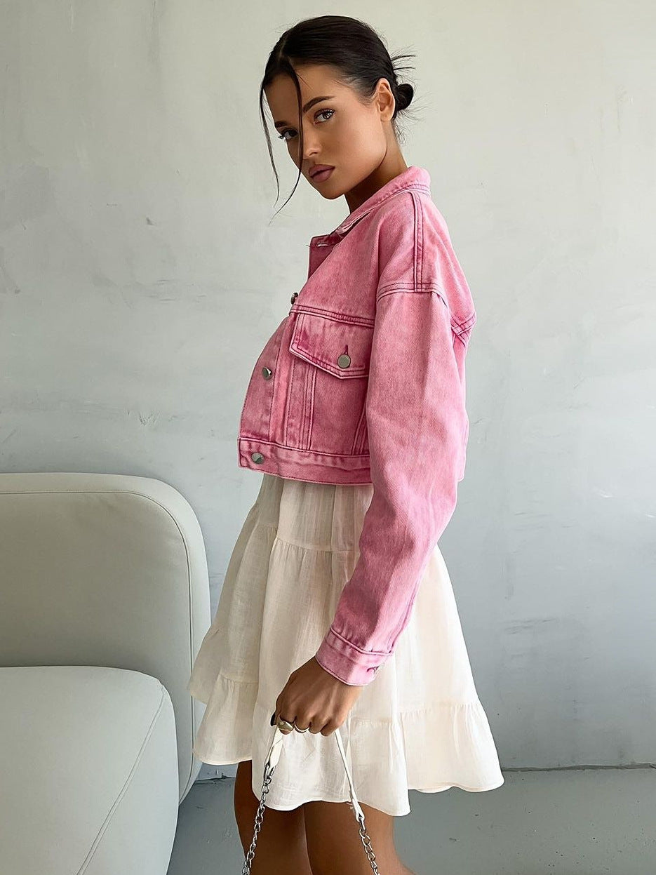 White spaghetti strap sundress with tiered skirt, layered with pink denim jacket and styled with chic smartphone and floral accessories