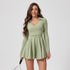 This olive green tennis dress combines sporty and chic elements with a long-sleeve design, a wrap-front detail, and a pleated skirt, making it ideal for on and off the court