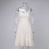 White spaghetti strap sundress with fitted bodice and flowy tiered skirt, styled with pink denim jacket and white sneakers