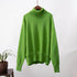 Emerald green turtleneck sweater hanging, soft knit texture, studio product shot