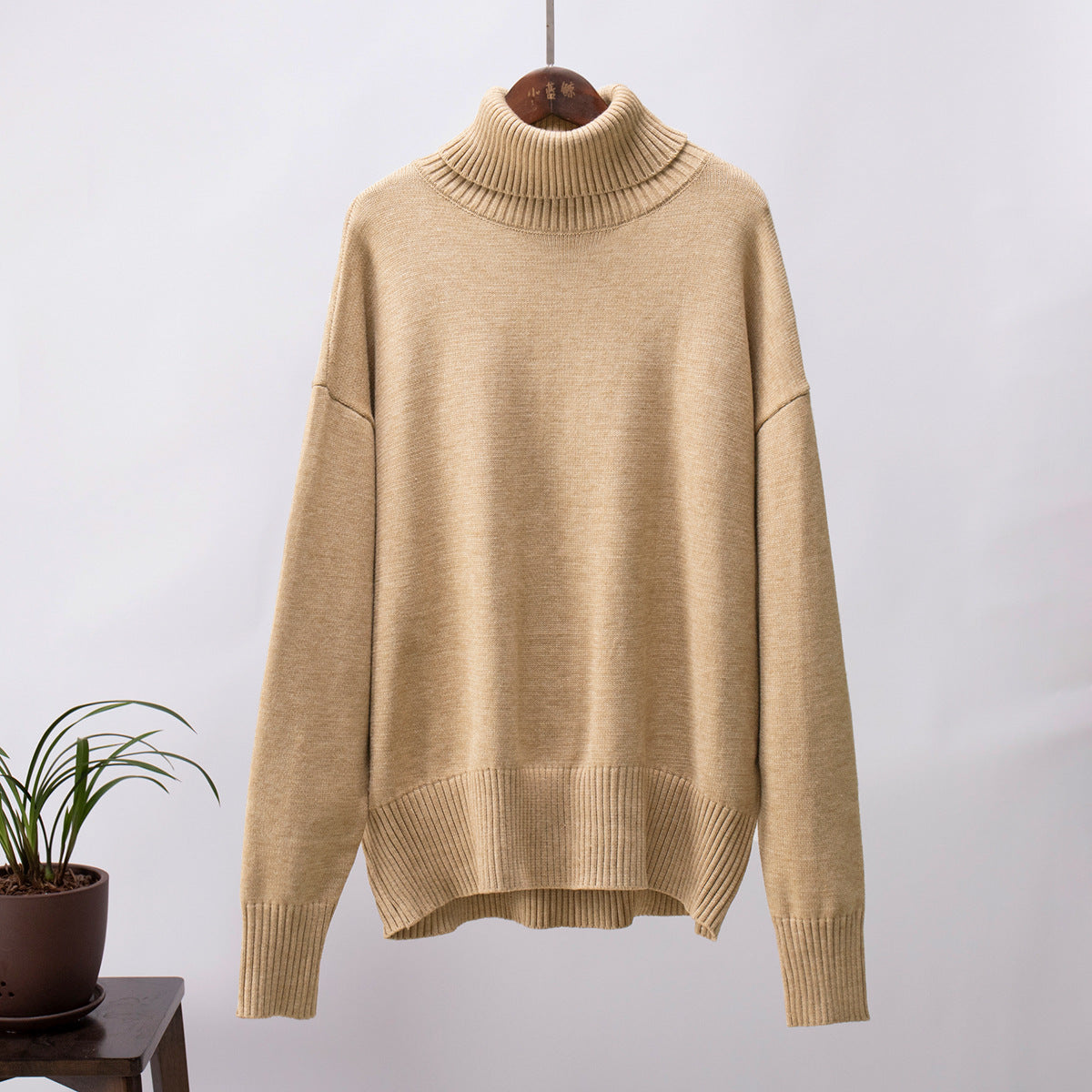 Warm beige oversized turtleneck sweater, dropped shoulders, cozy winter knit