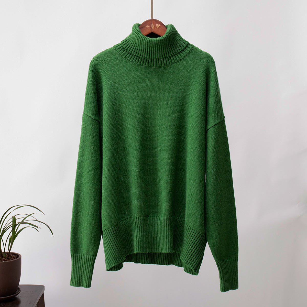 Emerald green turtleneck sweater, thick ribbed collar, modern minimalist design