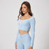 Baby blue workout set featuring long sleeve crop top with white piping, tie front detail and matching high-waisted athletic leggings with V-shaped waistband