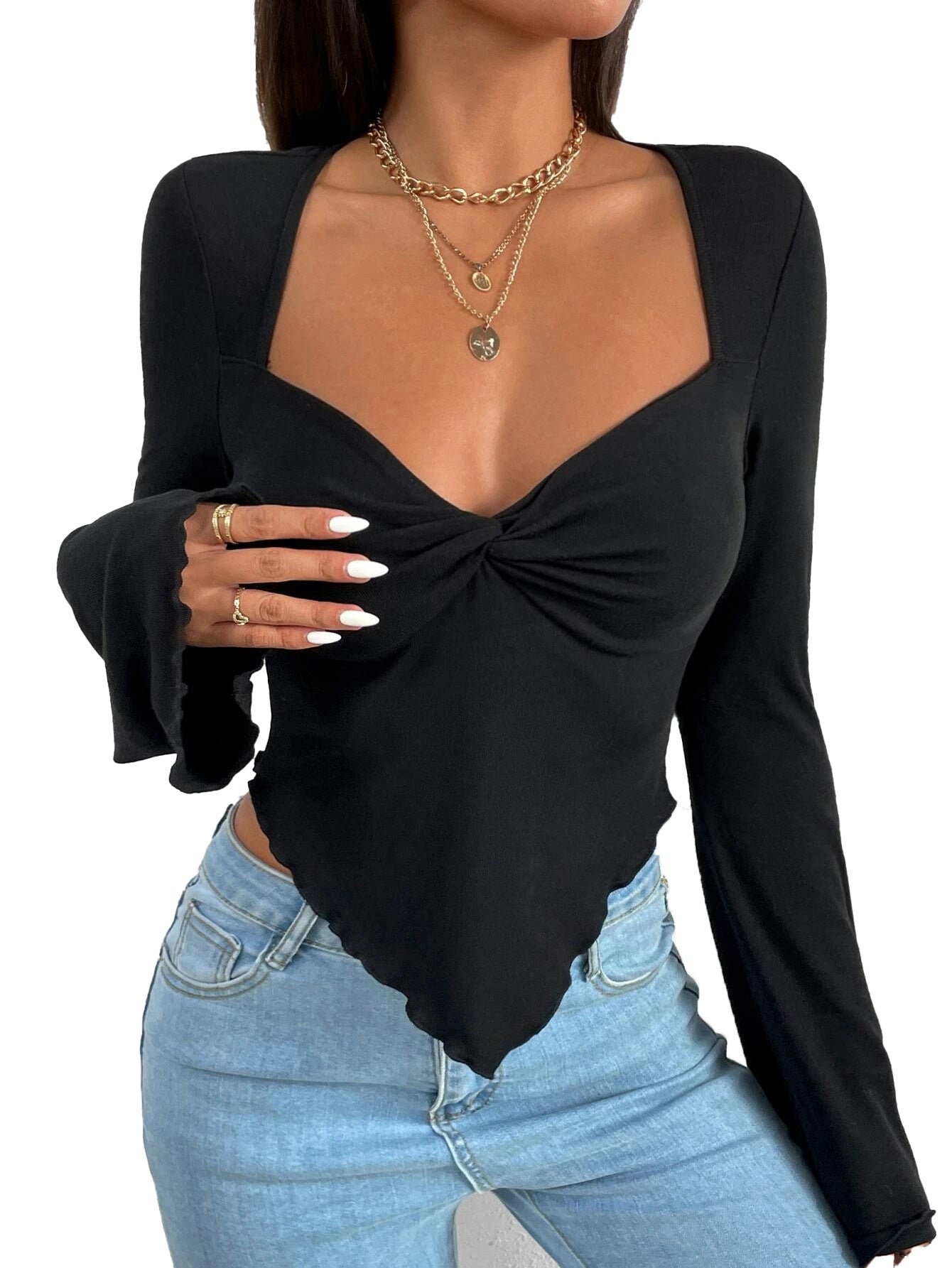 Detailed view of black sweetheart top with gathered front, white nails, and gold chain necklaces