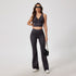 Full-length charcoal denim workout set with cropped tank and flared pants, styled with sunglasses and black shoulder bag