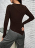 Back view of brown asymmetrical top showing unique seam detailing, paired with gray cargo pants