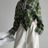Green plaid flannel tied at front with white sweatpants, minimalist casual look
