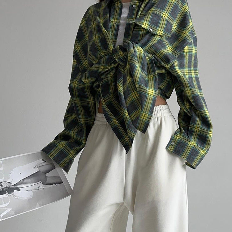 Green plaid flannel tied at front with white sweatpants, minimalist casual look