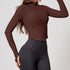 Woman modeling a chocolate brown ribbed zip-up cropped jacket with long sleeves and a fitted design