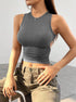 Gray sleeveless crop top with ruched waist, paired with khaki cargo pants, showcasing modern streetwear style