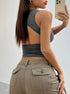 Stylish gray crop top with open-back detail, captured in mirror selfie with smartphone and silver necklace