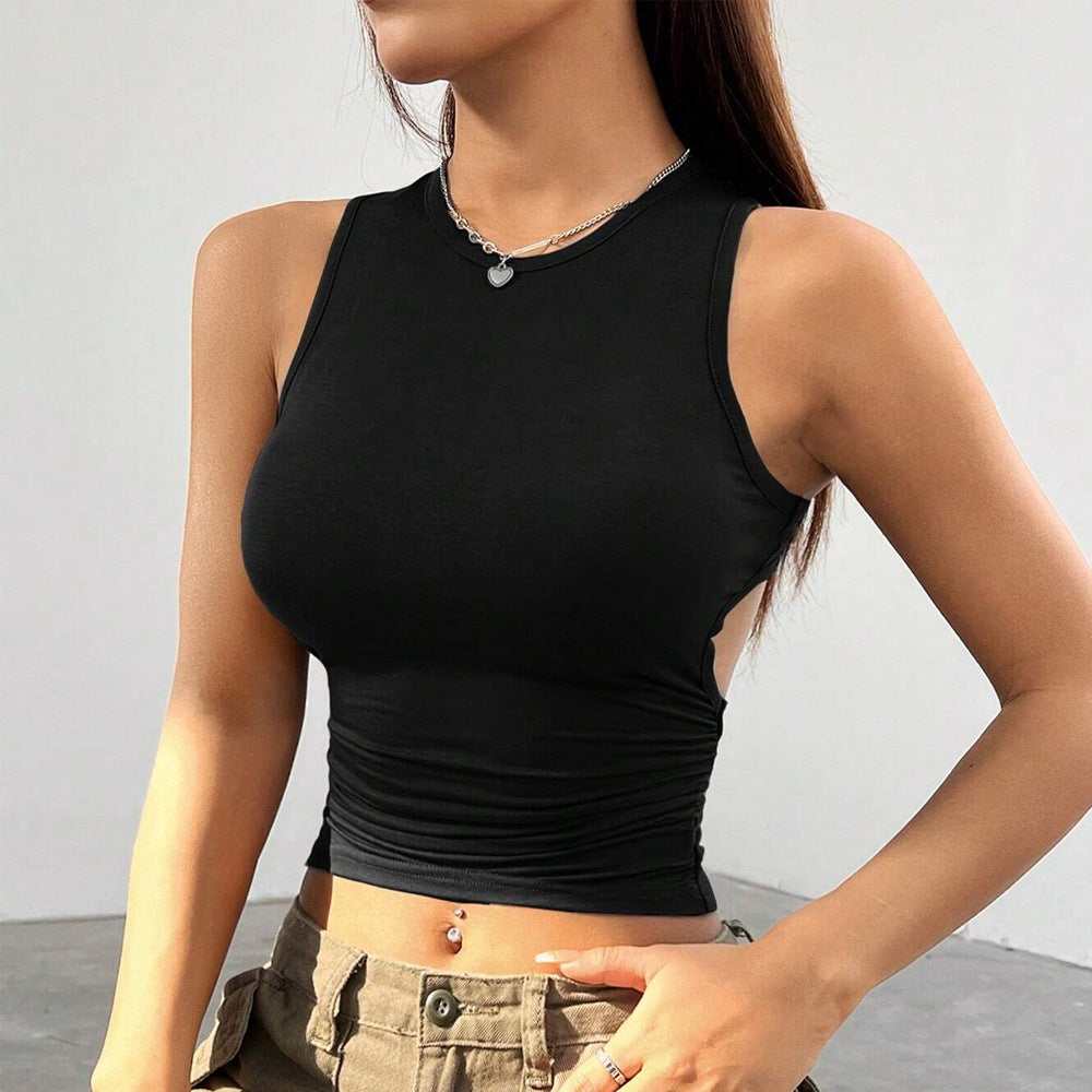 Black sleeveless crop top with high neckline and ruched waist, complemented by olive cargo pants