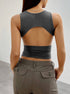 Back view of gray crop top with cut-out design, highlighting trendy open-back silhouette and fitted waistline