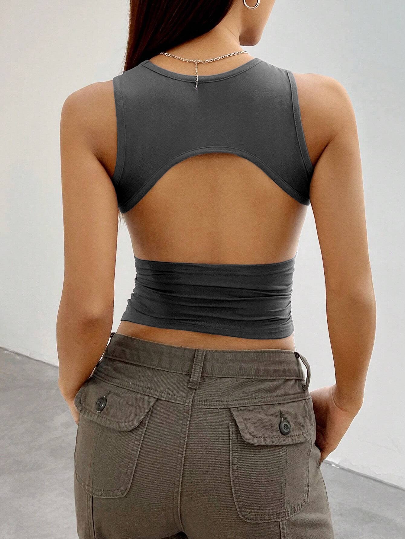 Back view of gray crop top with cut-out design, highlighting trendy open-back silhouette and fitted waistline