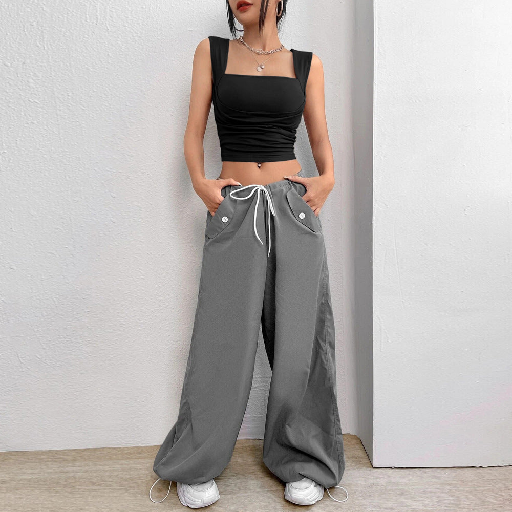 Black square neck crop top paired with grey wide-leg cargo pants, white sneakers and silver necklace, casual street style