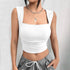 White square neck crop top with ruched detail, paired with grey drawstring pants and silver necklaces