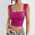 Magenta square neck crop top with ruched sides and wide straps, styled with grey pants and silver jewelry