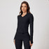 Model wearing a black ribbed workout set featuring a hooded jacket and fitted pants with split hem detail