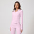 Model wearing a light pink ribbed workout set with hooded zip jacket and high-waisted leggings with thumb holes