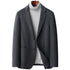 Charcoal gray wool blazer with notched lapels and two-button closure, styled with a light gray turtleneck sweater on wooden hanger