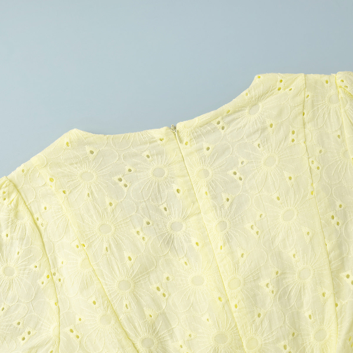 Yellow lace garment on a light blue background