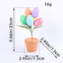 Easter egg tree with pastel speckled eggs and green leaves in a terracotta pot, 9.06in tall and 2.95in wide, shown against white.