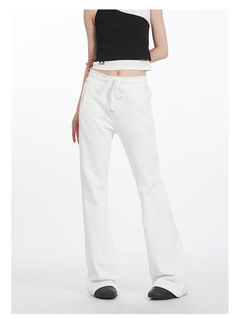 White flared athletic pants with drawstring waist, shown from front view