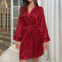 Deep red satin robe with black piping, featuring wide sleeves and wrap front design, evening loungewear