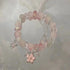 Rose quartz bracelet with silver cherry blossom charm and delicate chain accents