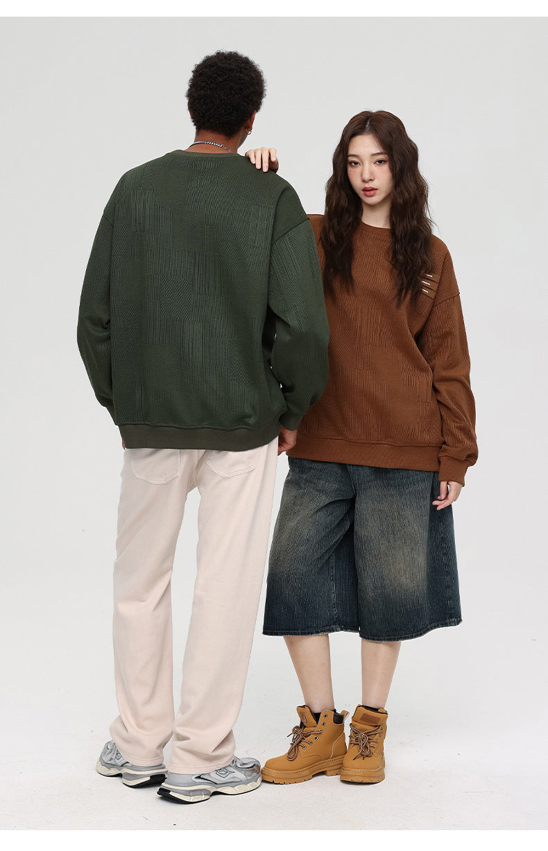Back view of models - man in olive textured sweatshirt with white pants, woman in brown sweatshirt with denim culottes