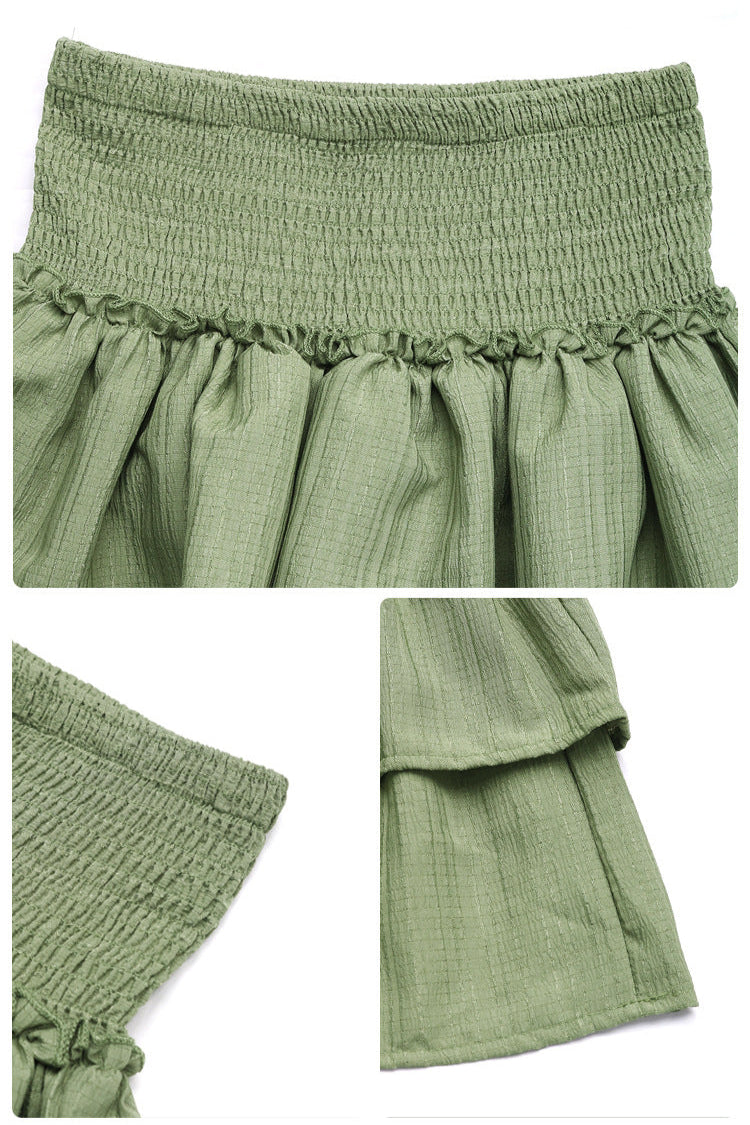 Close-up details of a sage green smocked mini skirt, featuring ruffled layers and textured fabric.