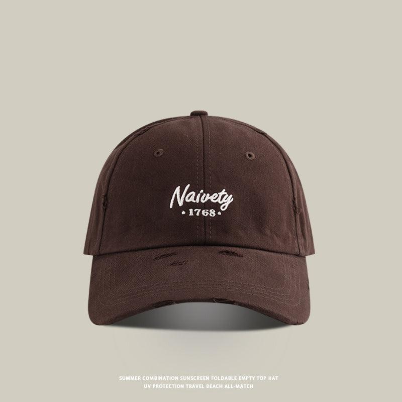 Brown baseball cap with white 'Naivety 1768' embroidered logo