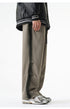 Side view of gray wide-leg pants featuring a subtle black stripe along the seams