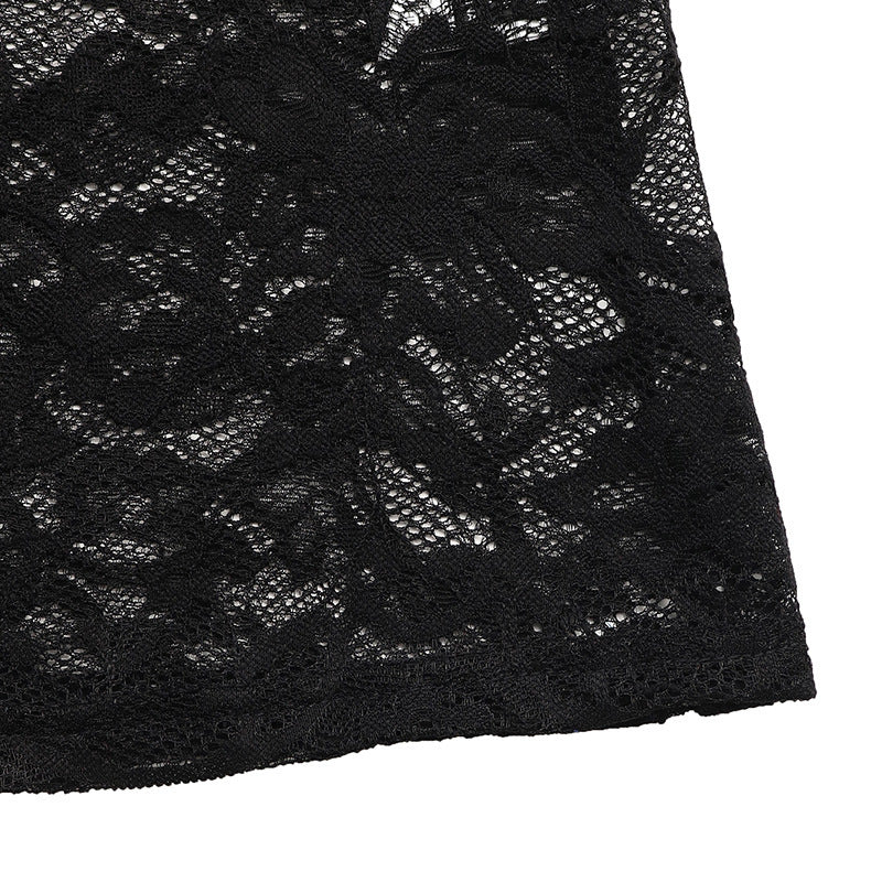 A close-up of the intricate black lace fabric at the dress's hem, showing the delicate floral pattern.