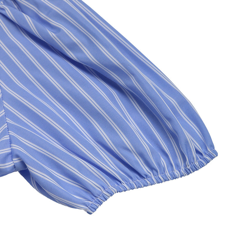 A close-up of the puff sleeve with elasticized cuffs on the blue striped dress.