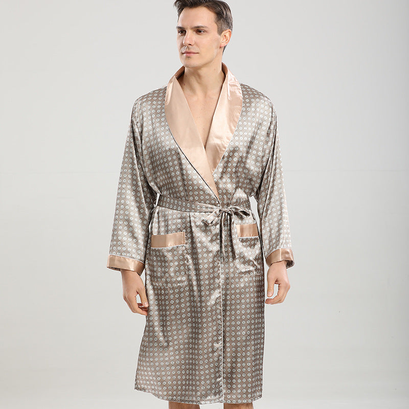 Man in champagne and taupe geometric print robe. Close-up shows contrast satin lapels and patch pockets with coordinating trim against neutral background