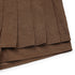 Zoomed-in detail of the pleated layers of the brown mini skort, showing the fabric thickness.