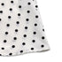 Hem detail of a white polka dot dress, showcasing the fabric’s lightweight and soft texture.