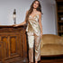 Satin two-piece pajama set with delicate floral print in cream and gold tones, showcasing a camisole top and wide-leg pants