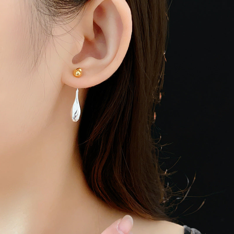 Two-tone gold and silver Water Drop dangle earrings on ear