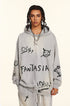 Model with twisted braids wearing light gray hoodie with graffiti-style graphics featuring 'FANTASIA' text and devil emoji designs