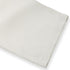 Hem detail of white linen pants, showing neatly stitched wide-leg cut.