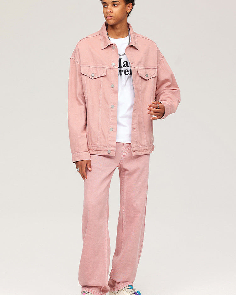 Model wearing pink denim jacket and pants set with white graphic tee and chunky sneakers