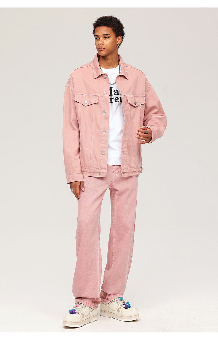 Model wearing pink denim jacket and pants set with white graphic tee and chunky sneakers