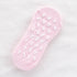 Light pink non-slip ankle sock with white footprint grip pattern on sole displayed flat against white fabric background