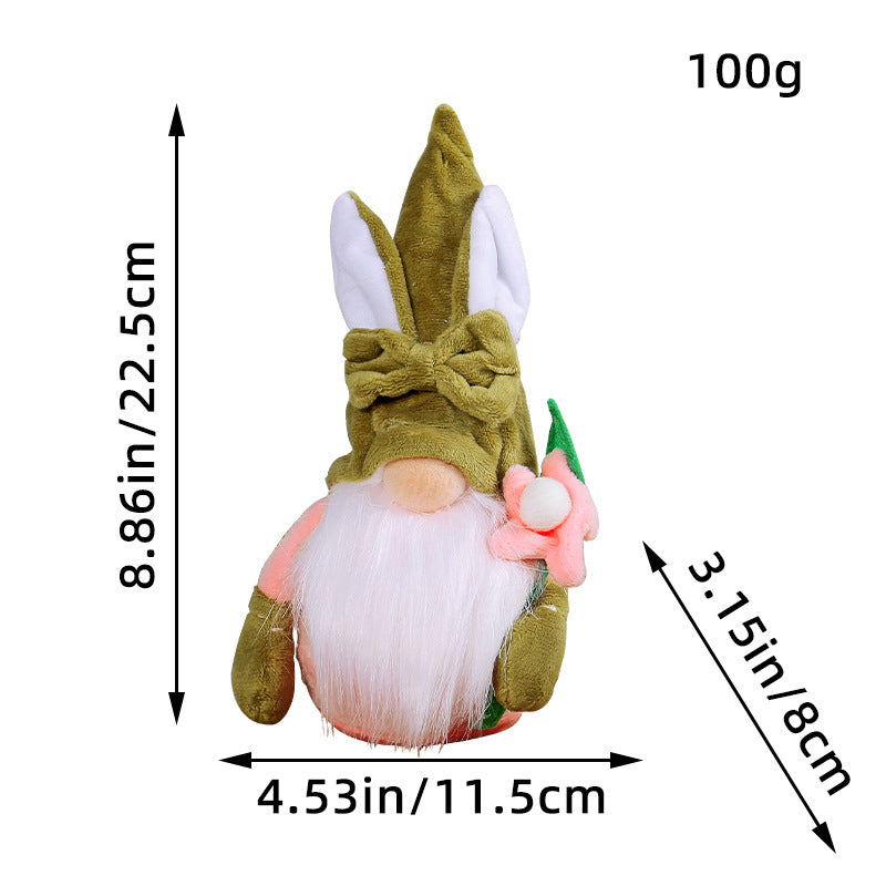 Easter gnome with an 8.86in (22.5cm) green hat, white bunny ears, tied fabric bow, white beard, and a pink flower.