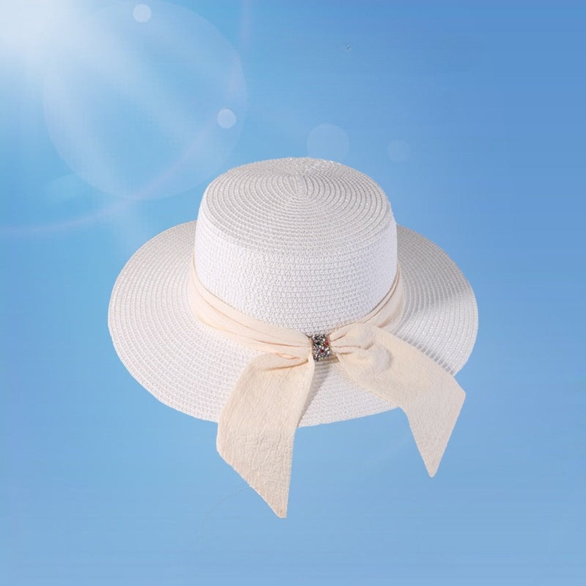 Classic white straw sun hat for women with a wide brim and a decorative bow. A sophisticated summer accessory for beach vacations or city walks.
